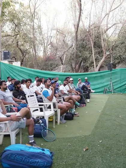 Addressing the attendees of the tennis coaching certification program. It's vital for coaches to understand the principles of biomechanics and conditioning to help their players stay healthy and perform at their best.