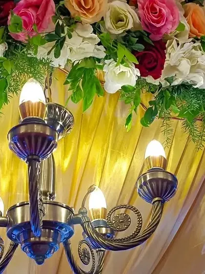 A close-up of the details. We often incorporate beautiful elements like this vintage-style chandelier into our stage designs to add warmth and elegance.