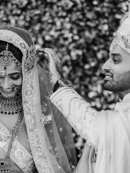 A tender black and white moment during the wedding ceremony. The groom's gentle gesture and the bride's happy smile say it all.