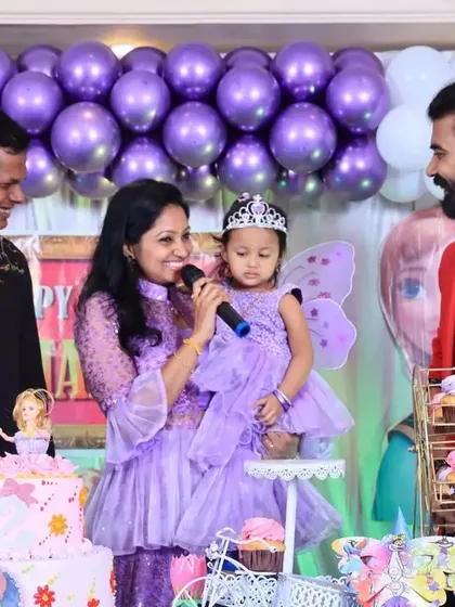 The birthday girl, dressed as a fairy, enjoying her moment in the spotlight.