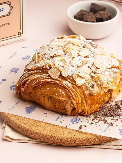 My limited edition Pain au Chocolat Almond is a true indulgence. It combines the richness of a chocolate croissant with a crunchy, nutty almond topping.
