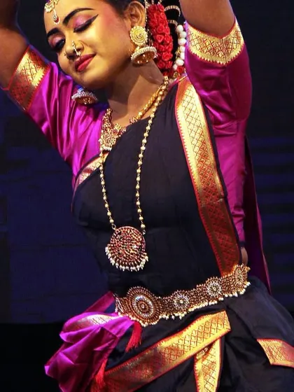 A close-up of a dancer's in a moment of serene expression, her eyes conveying a world of emotion during the 'Ayyappa Kavuthuvam'.