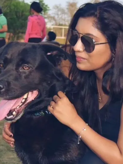 A beautiful black lab enjoying some outdoor time with his human. We welcome all breeds and ensure they get the love and attention they deserve.