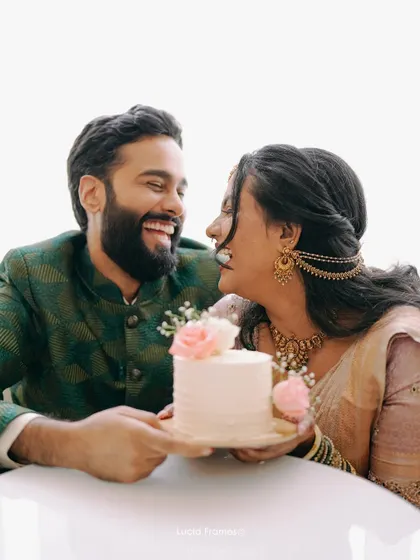 A sweet, happy moment between the couple over their celebration cake.