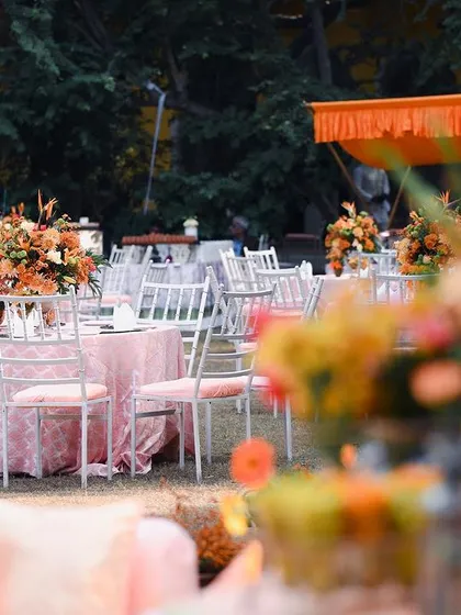 The overall layout of the garden Mehendi, showing the balance between the dining tables and the relaxed lounge seating. The entire space felt cohesive, with the peach and orange palette tying everything together.