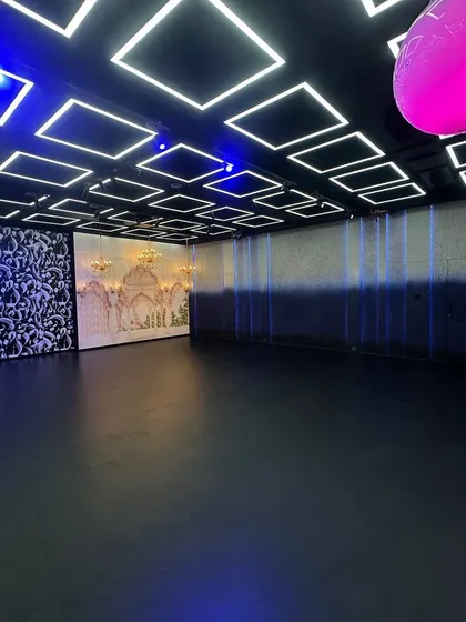 Take a look at the possibilities. This wide shot shows our main production floor where you can see the Haveli set, abstract art panels, and our signature geometric LED ceiling grid all in one frame. We designed this space so you can switch between completely different looks in minutes.