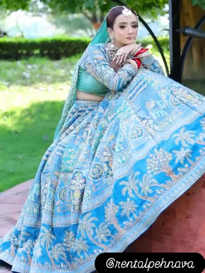 A stunning sky blue lehenga with intricate threadwork, perfect for a day wedding or a summer bride.