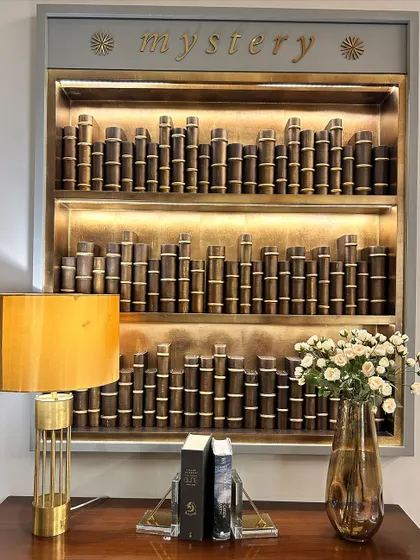 A beautiful bookshelf with the word "mystery" on top. This is a reminder to embrace the unknown and become comfortable with uncertainty. Life is never linear, and you will only grow wiser.