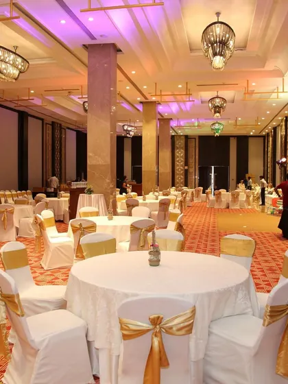 The ballroom setup for the Hawaiian party. Even in a classic ballroom, I use decor, lighting, and table settings to bring the chosen theme to life.