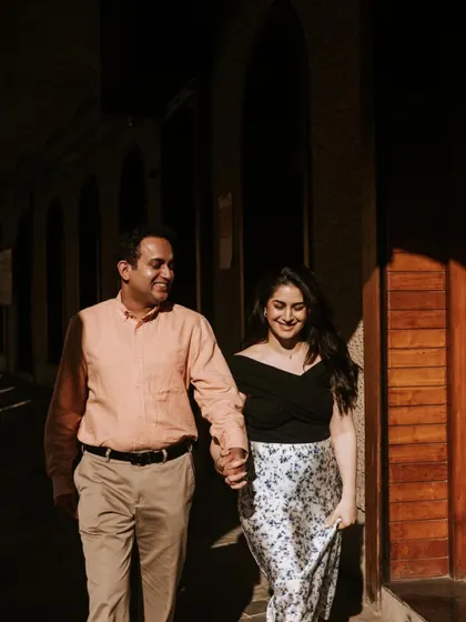 Walking hand in hand through a sunlit corridor. I love playing with natural light and shadows to create depth and a romantic atmosphere in my couple portraits.