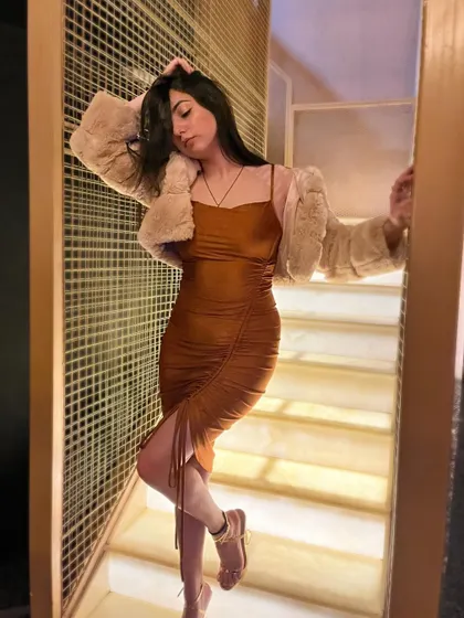 A moody, artistic shot on the stairs, highlighting the texture of the dress and jacket.