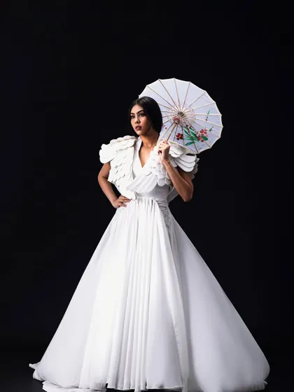 An avant-garde look for an editorial concept titled "YUME". The makeup and hair are clean and minimal to complement the sculptural white gown and artistic direction of the shoot.