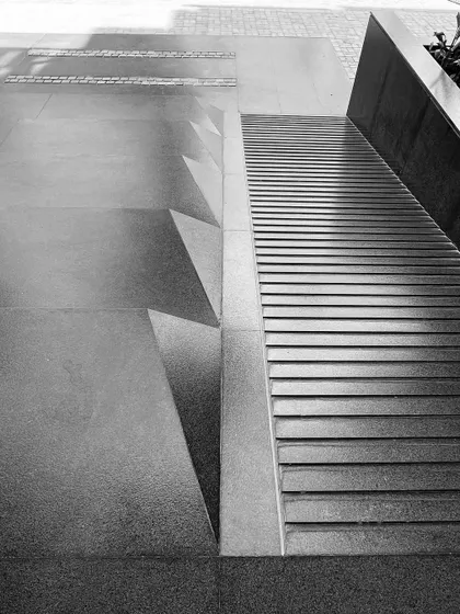 A detail of the entrance at the 'Treehouse' project, showing the careful articulation of steps and ramps. This focus on circulation ensures accessibility while creating a strong graphic and textural quality.