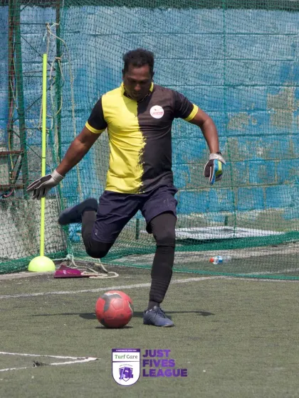 A goalkeeper prepares to clear the ball upfield. The role of every player is crucial in the fast-paced five-a-side format.