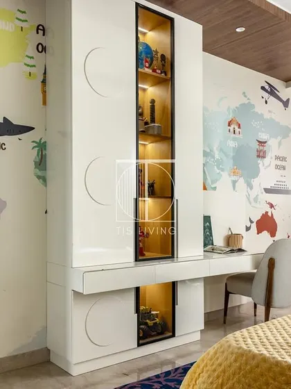 We also designed this smart study and storage unit for the same room. The integrated desk, display shelves, and closed cabinets provide ample space for learning and organizing, all tied together with a fun world map wallpaper.