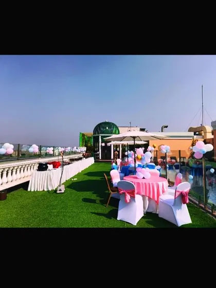 An overview of the rooftop party space, with decorated tables and chairs set up for guests to enjoy the celebration.
