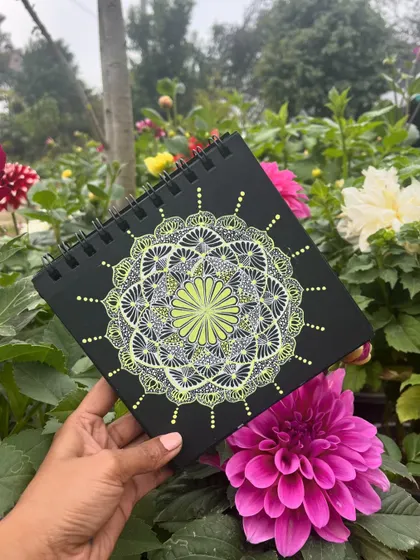 A delicate lime and white mandala, looking beautiful amongst flowers.