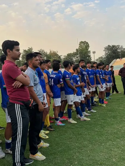 The calm before the storm. The team lined up, waiting for the trophy presentation after a hard-fought season. This is a moment of pride for the entire club.