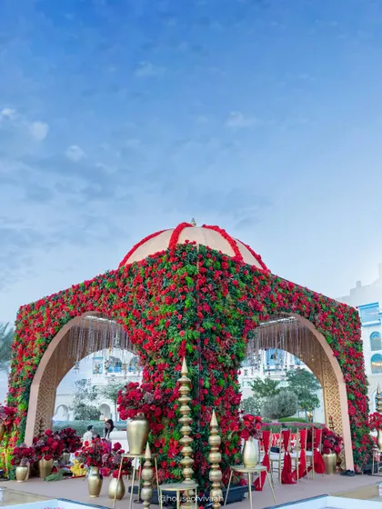 A breathtaking floral mandap at Salwa Beach Resort, Doha, completely covered in red flowers with a domed top, embodying the grandeur of our "Royal Rajputana" theme.