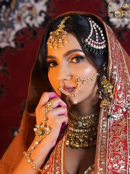 Inspired by the grandeur of Heeramandi, this look is all about royal elegance. The focus is on the expressive eyes, with a warm, coppery eyeshadow and a classic nath that adds a touch of old-world charm.