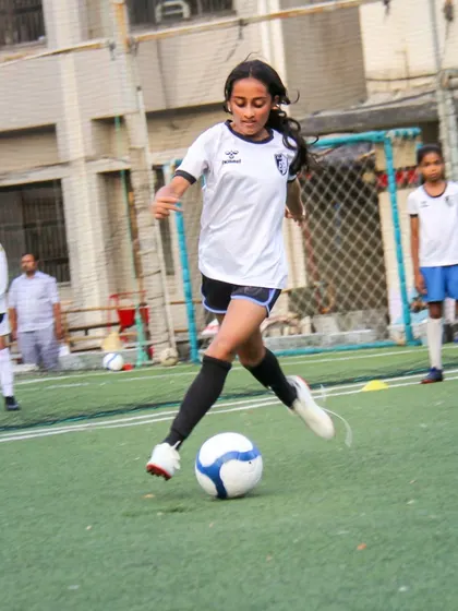 A powerful kick towards the goal shows passion and purpose. Our training for older girls in the U12 and U14 batches focuses on translating practice into powerful game-day performance.
