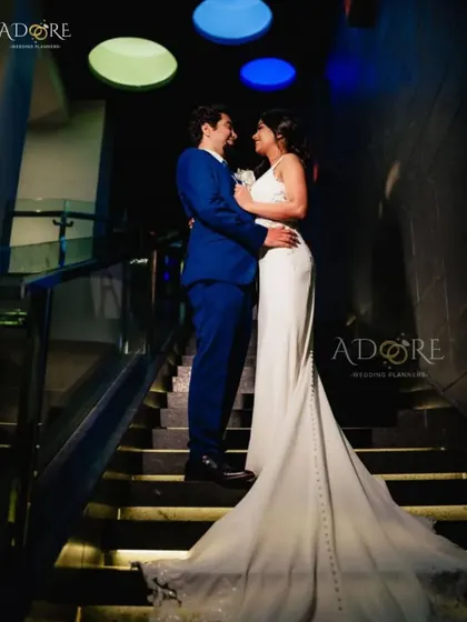 A candid moment between the couple during their reception. We design spaces with great lighting and multiple photo opportunities in mind, like this modern staircase, ensuring your photographer can capture beautiful memories.