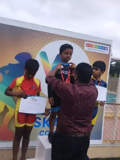 The moment of victory. Our coach awards a medal to one of our champions on the podium, recognizing his outstanding performance in the competition.