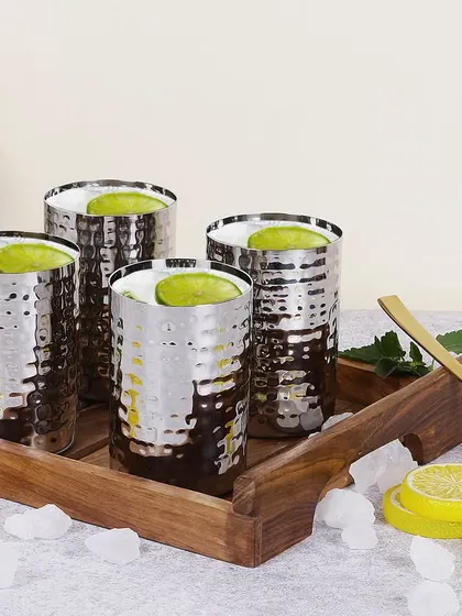 Another variation of the hammered steel glasses, this time with a green drink. This shows the product's versatility and provides the client with multiple visual options for their marketing.