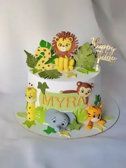 Another take on the jungle theme, this cake for Myra's 2nd birthday features a lion, monkey, elephant, and tiger among the green leaves.