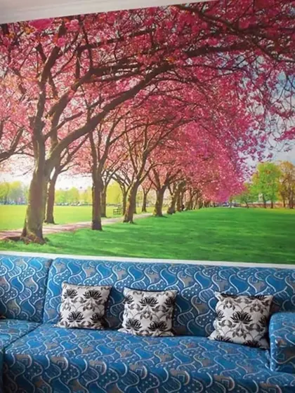 A beautiful cherry blossom tree mural creates a stunning feature wall, bringing the beauty of spring into the living room year-round.