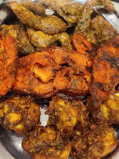 A platter showcasing a mix of our fish and chicken starters. The combination of textures and marinades makes for a delightful appetizer course.