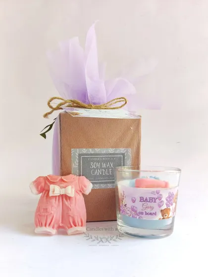 The complete baby shower gift box, featuring the layered candle and onesie sachet, elegantly wrapped and tagged.