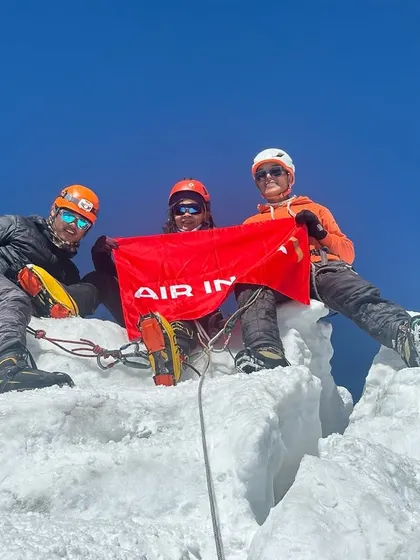 A successful summit on Mt. Lobuche (6,119m) in Nepal. The team celebrates on the sharp, icy peak, a testament to their skill and endurance.