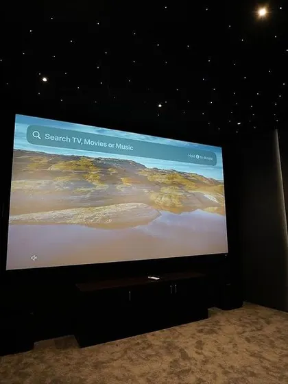 A straight-on view of the Grandview 135-inch screen, ready for any movie or show. The dark, non-reflective walls and ceiling prevent any light bleed, ensuring a high-contrast, cinematic picture.
