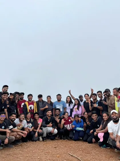 A large group of happy trekkers celebrating at the summit. The more, the merrier on our weekend trips.