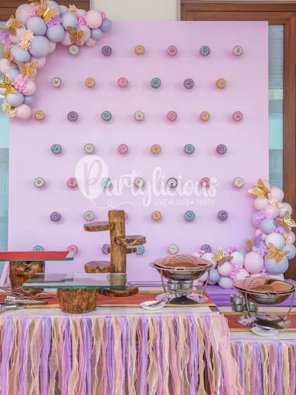 A beautiful pastel donut wall, serving as both a delicious treat station and a stunning piece of decor.