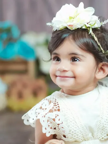 A close-up portrait capturing a sweet, gentle smile. The vintage theme is perfect for these soft and delicate shots.