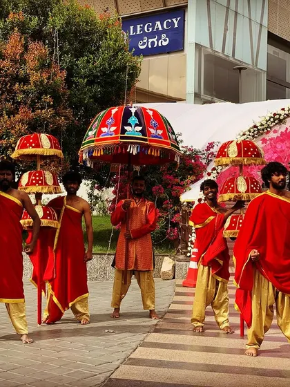 A closer look at the traditional umbrella entry for the groom. Our performers, in coordinated attire, create a regal pathway for his arrival.