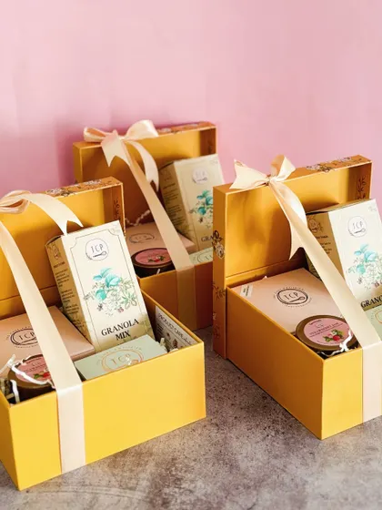 Our Utkarsha Box Hamper is another perfect way to express gratitude. This elegant yellow floral box contains a signature tea cake, granola, strawberry jam, and our OG chocolate cookies.