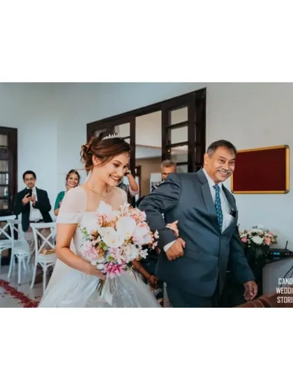 The bride's joyful walk down the aisle with her father, a cherished and emotional moment.