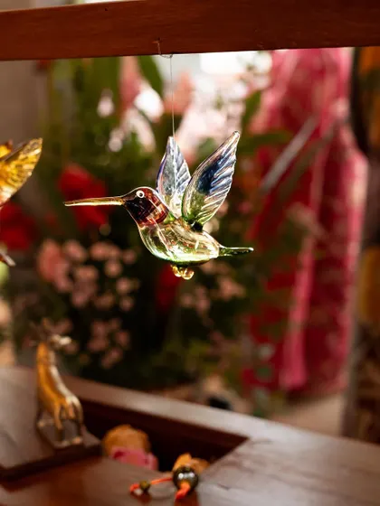 A delicate glass hummingbird, one of the many beautiful craft pieces showcased at our workshop. These small details can add so much personality and charm to any space.
