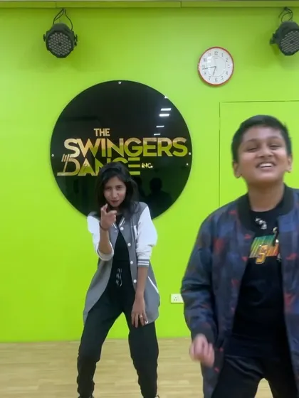 Another great moment from our teacher-student showcase. An instructor points to the camera while her young student dances with joy and confidence.