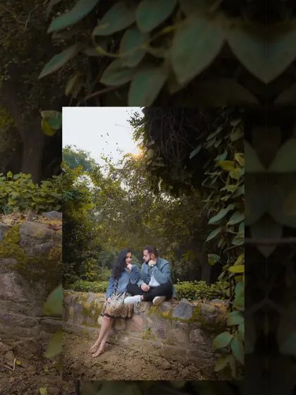 A wide shot that sets the scene for their romantic park photoshoot. The natural foliage frames them perfectly, creating a sense of intimacy and seclusion.