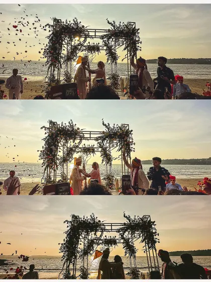 A wide shot of the wedding ceremony on the beach at sunset in Goa, capturing the epic scale and beauty of the event.