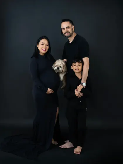 Even furry family members are welcome in our studio. This beautiful family portrait includes their beloved dog, making it a complete and heartwarming picture.