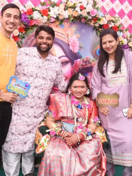 More fun with props! Guests hold up "Chachu" and "Chachi" signs, posing with the radiant mom-to-be.
