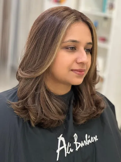 The client looking happy and confident with her new hair color.
