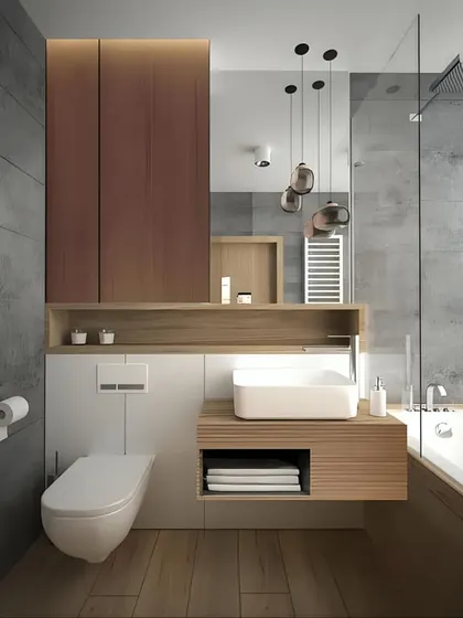This compact bathroom design is incredibly efficient. It combines wood and white finishes, with a floating vanity and toilet to save space. The pendant lights add a stylish touch.