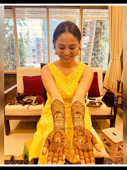 The beautiful bride-to-be, so happy with her personalized engagement mehendi. Her smile says it all!