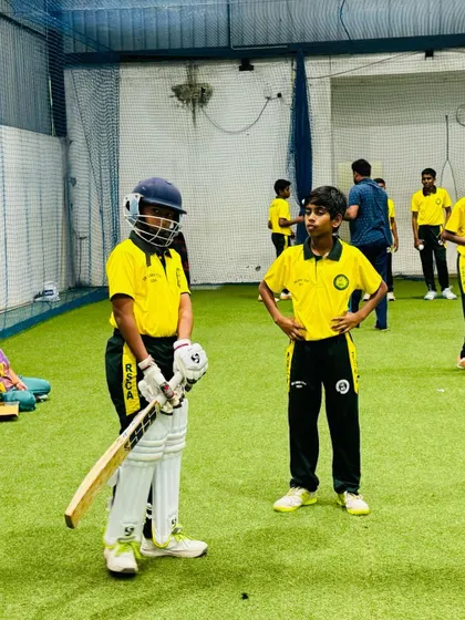 A young cricketer gets ready to face the next ball during an indoor net session, a key part of our residential cricket program.